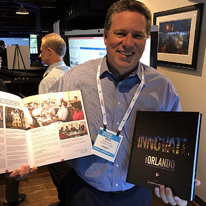 Pete holding "Innovate Orlando" books at "Innovate Orlando" launch party