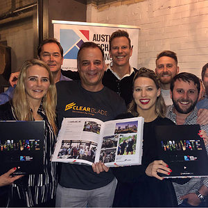 Group of people holding an "Innovate" book at launch party