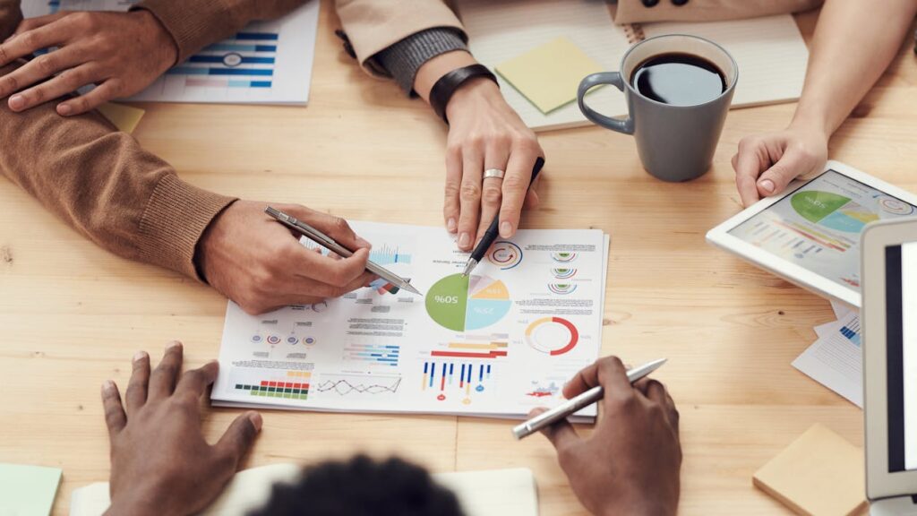 Directors reviewing reports and charts during a board meeting