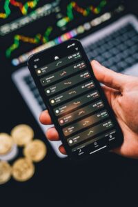 Hand holding a phone showing a cryptocurrency portfolio