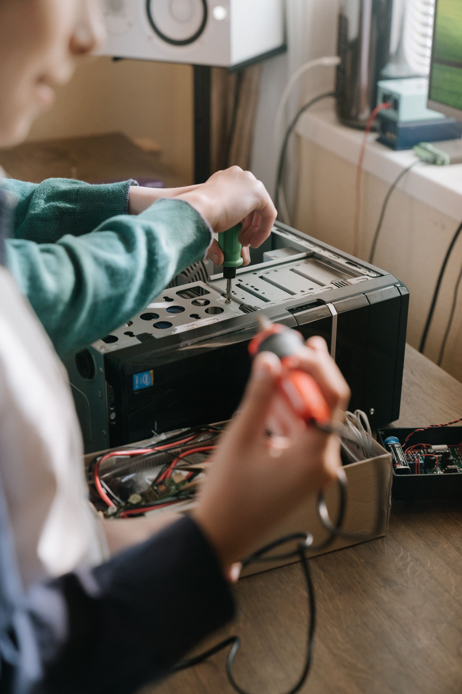 Repairing an appliance with hand tools and a circuit board on the bench