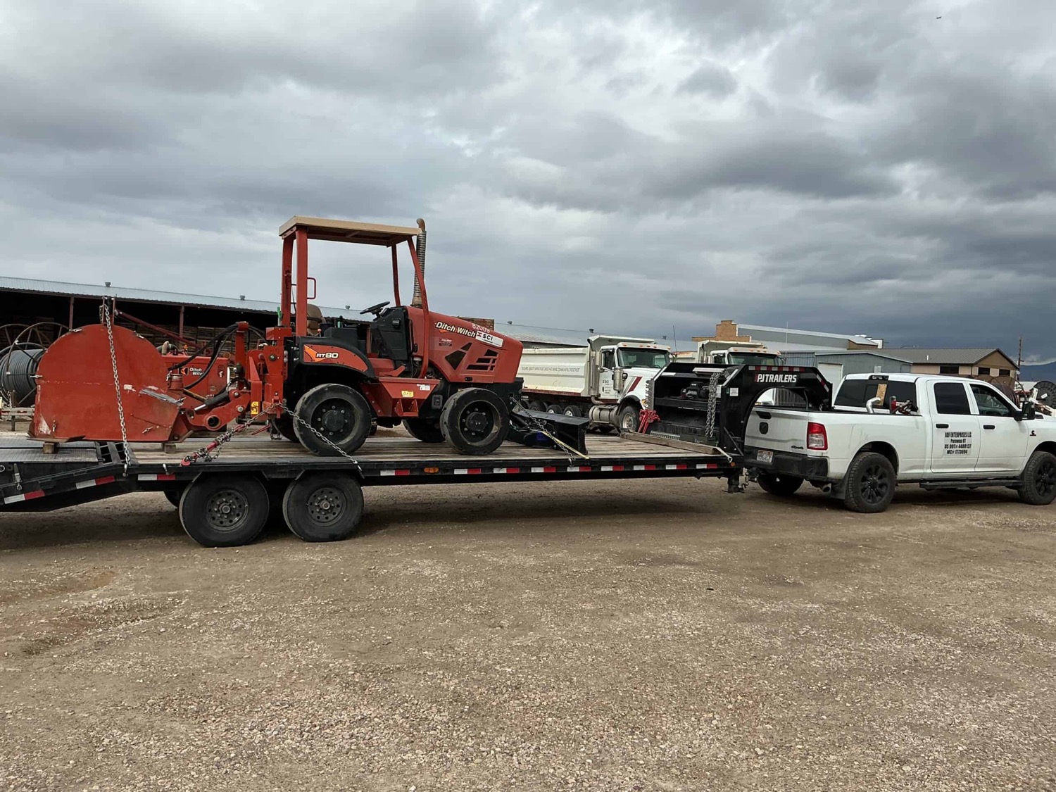 Hotshot truck hauling a compact utility machine on a gooseneck trailer