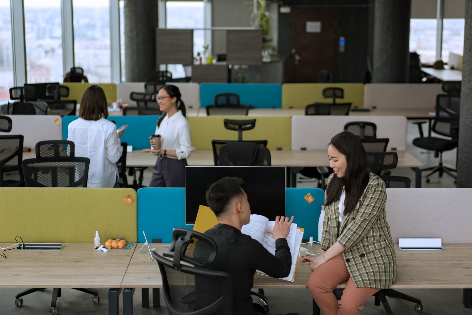 Colleagues talking in an open shared workspace